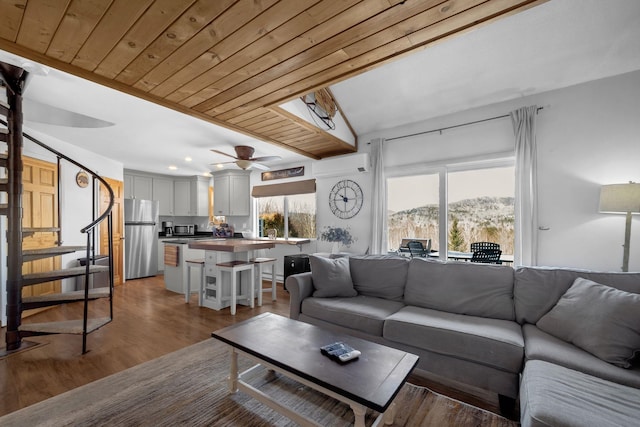 living room with stairway, wood finished floors, ceiling fan, wooden ceiling, and a mountain view