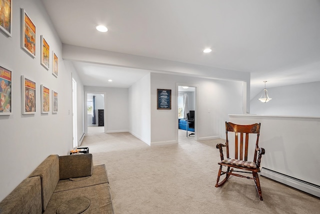 living area featuring recessed lighting, a baseboard radiator, and light colored carpet