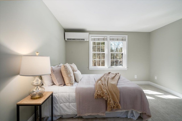 carpeted bedroom with an AC wall unit and baseboards