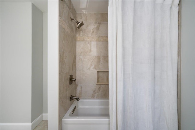 full bath featuring shower / bath combination with curtain and baseboards