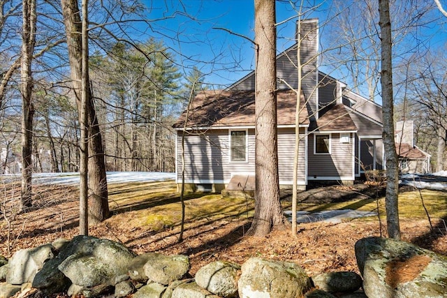 back of property with a chimney