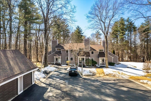 view of front of house with a chimney and a garage