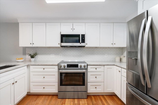 kitchen featuring white cabinetry, light wood-style floors, and appliances with stainless steel finishes