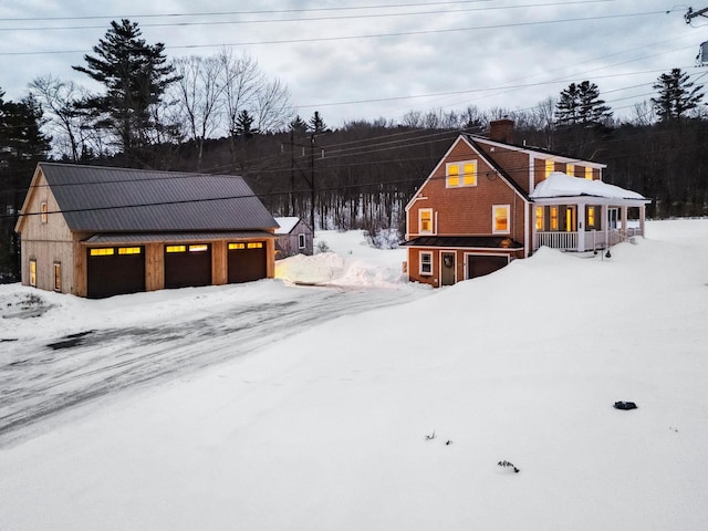 chalet / cabin with a garage, an outbuilding, and a chimney