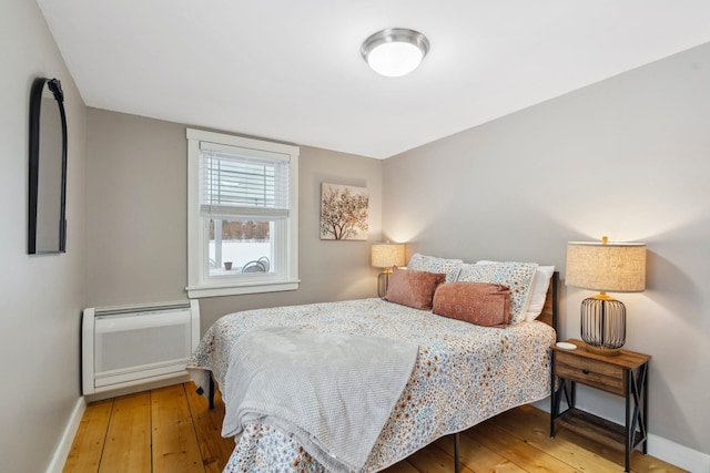 bedroom featuring baseboards and wood-type flooring