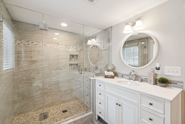 full bathroom with vanity and a shower stall