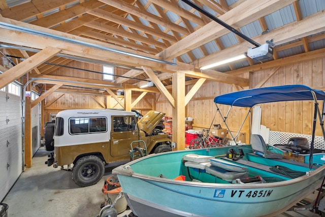 garage featuring wooden walls and a garage door opener