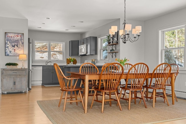 dining area featuring a notable chandelier, light wood-style floors, and recessed lighting