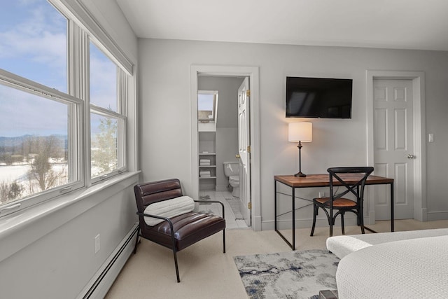 interior space with light carpet, baseboards, and a baseboard radiator