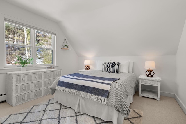 bedroom with lofted ceiling, light colored carpet, and baseboards