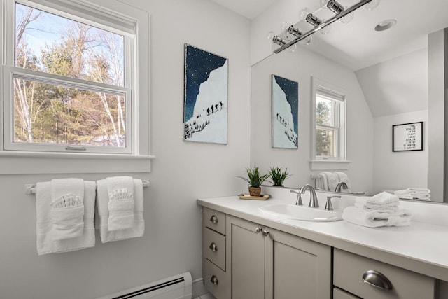 bathroom with vanity, a baseboard heating unit, and vaulted ceiling