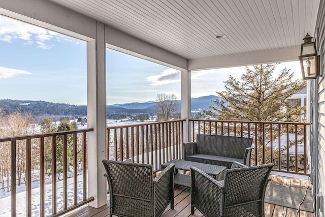 wooden deck featuring a mountain view and outdoor lounge area