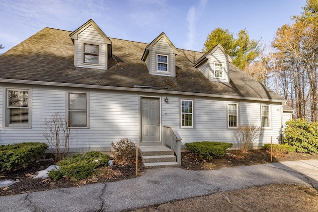 cape cod-style house featuring a shingled roof