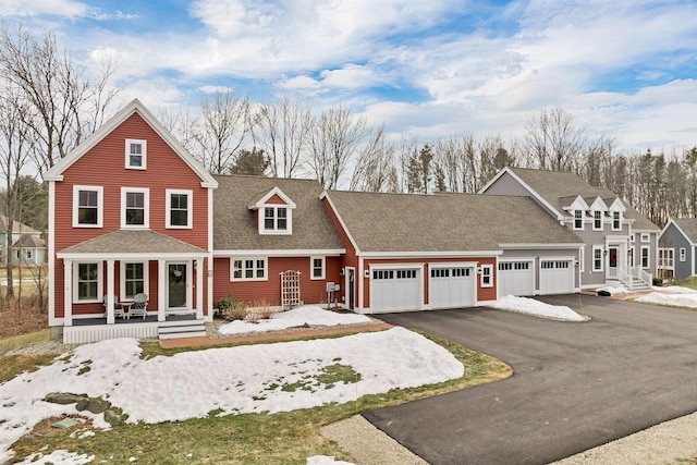 view of front of house with a porch, driveway, a shingled roof, and a garage