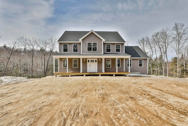 view of front of property with covered porch and roof with shingles