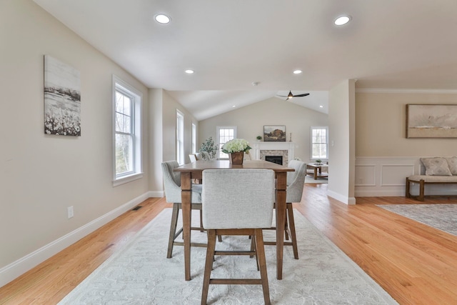 dining room featuring recessed lighting, a fireplace, and light wood-type flooring