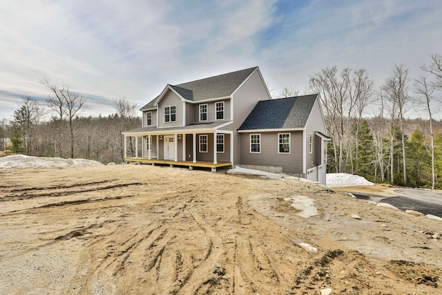 view of front of house with roof with shingles and covered porch