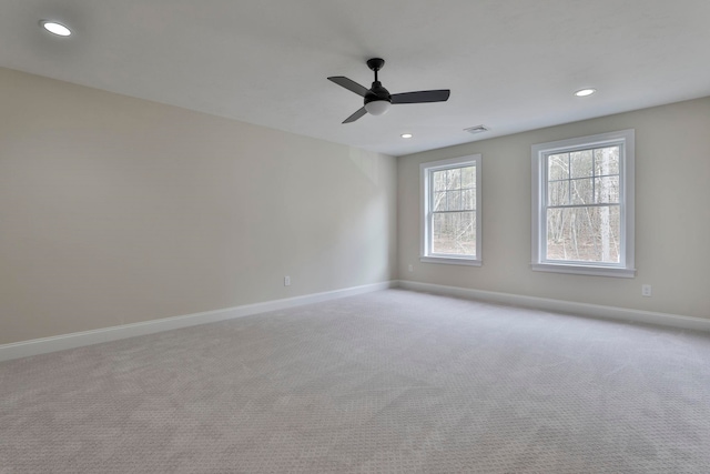 carpeted spare room with recessed lighting, visible vents, baseboards, and a ceiling fan