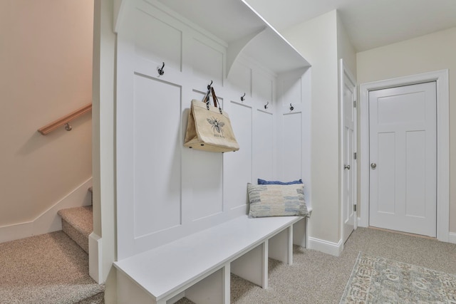 mudroom with light colored carpet and baseboards