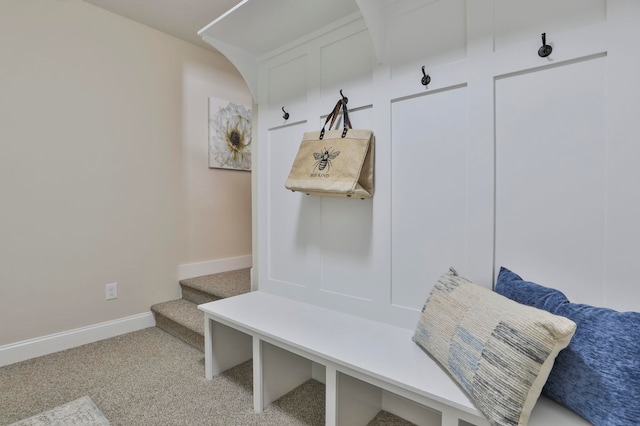 mudroom featuring baseboards and light carpet