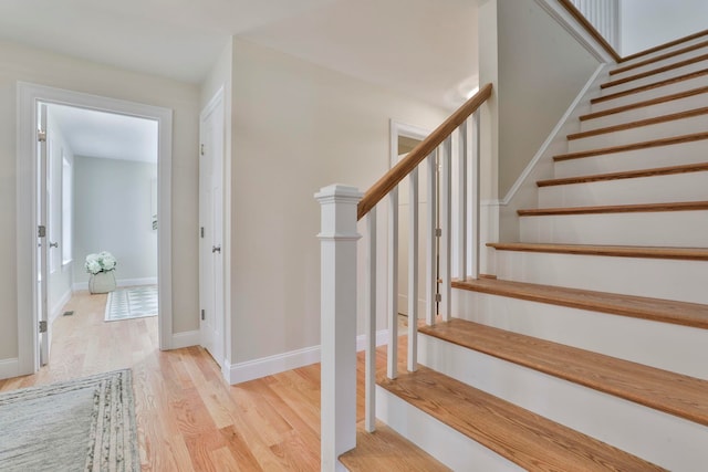 stairs featuring baseboards and wood finished floors