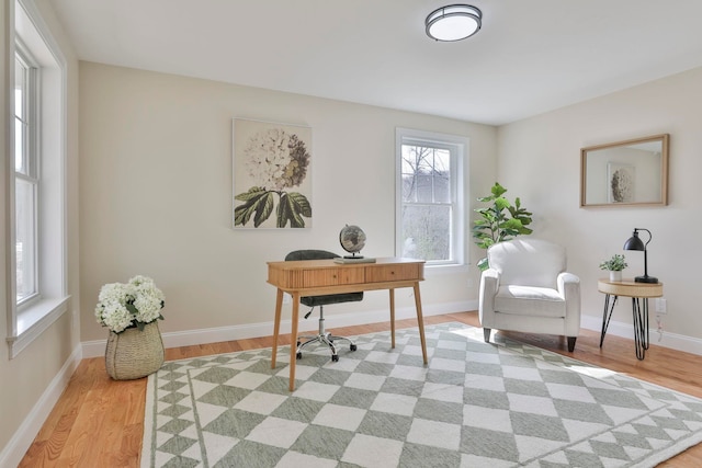 home office with baseboards and light wood-style floors