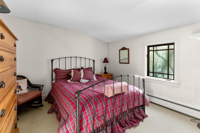 bedroom featuring a baseboard heating unit and carpet