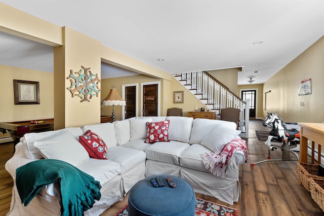 living area with stairs and wood finished floors