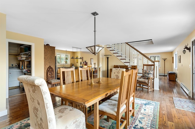 dining room with light wood-type flooring, stairs, baseboards, and a baseboard radiator