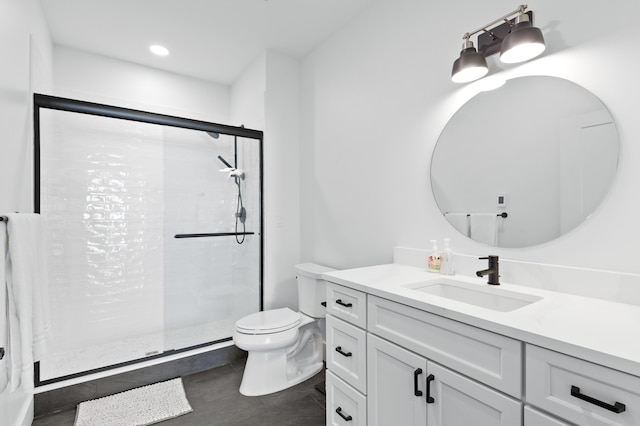 bathroom with tile patterned flooring, a shower stall, toilet, and vanity