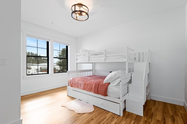 bedroom featuring wood finished floors and baseboards