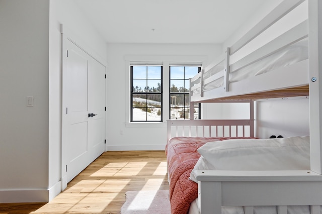 bedroom with light wood-style floors and baseboards