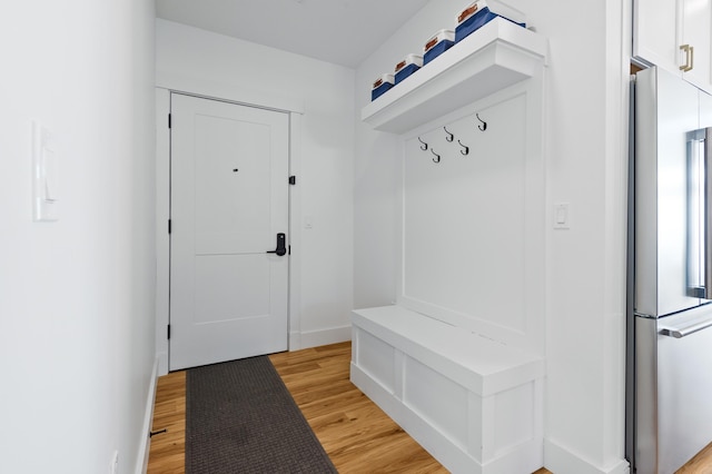 mudroom with baseboards and light wood-type flooring