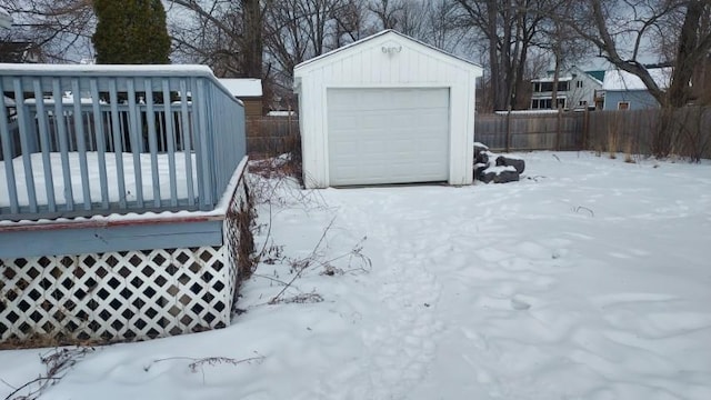 yard covered in snow with an outdoor structure and fence