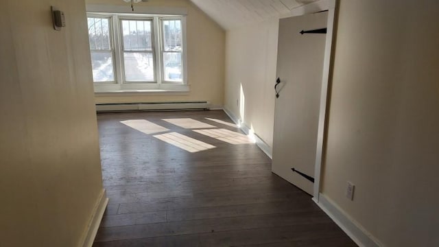 bonus room with baseboards, dark wood-type flooring, baseboard heating, and vaulted ceiling