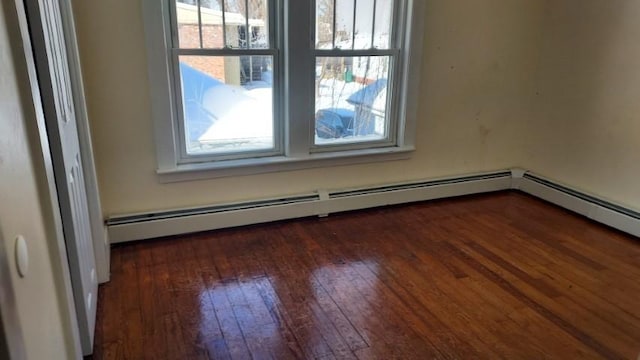 spare room featuring a wealth of natural light and hardwood / wood-style flooring