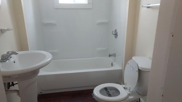 bathroom with shower / bathing tub combination and toilet