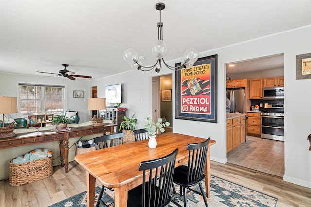 dining space featuring ceiling fan with notable chandelier, baseboards, light wood finished floors, and ornamental molding