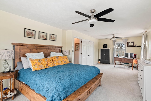 bedroom featuring light colored carpet and a ceiling fan