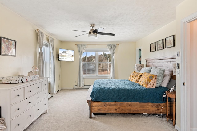 bedroom featuring light carpet, a textured ceiling, a baseboard heating unit, and a ceiling fan