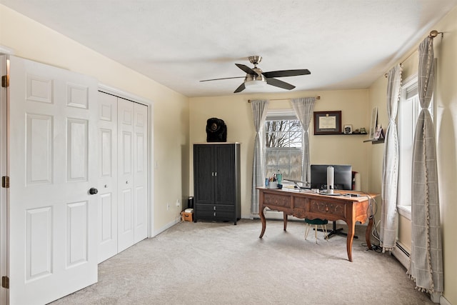 office area with baseboards, carpet floors, and ceiling fan