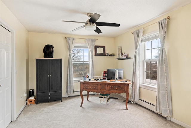 carpeted office featuring baseboards and ceiling fan