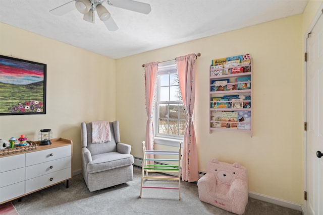 sitting room with baseboards, a ceiling fan, and carpet floors