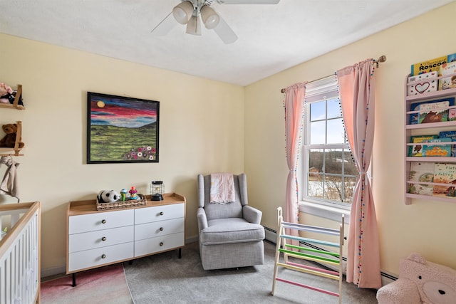 interior space with carpet flooring, a ceiling fan, and a baseboard radiator