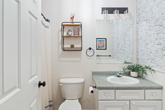 bathroom featuring toilet and vanity