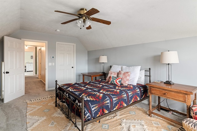 bedroom featuring a ceiling fan, a textured ceiling, carpet floors, baseboards, and vaulted ceiling