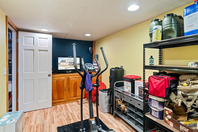 workout room featuring recessed lighting, wood finished floors, and a paneled ceiling