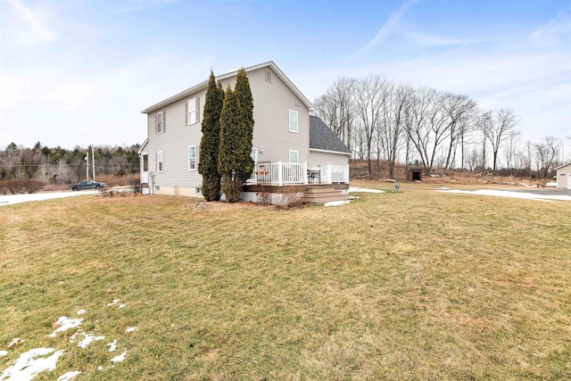 view of property exterior with a lawn and a deck