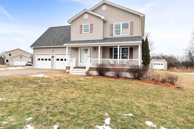 traditional-style house with a shingled roof, a front yard, covered porch, driveway, and an attached garage