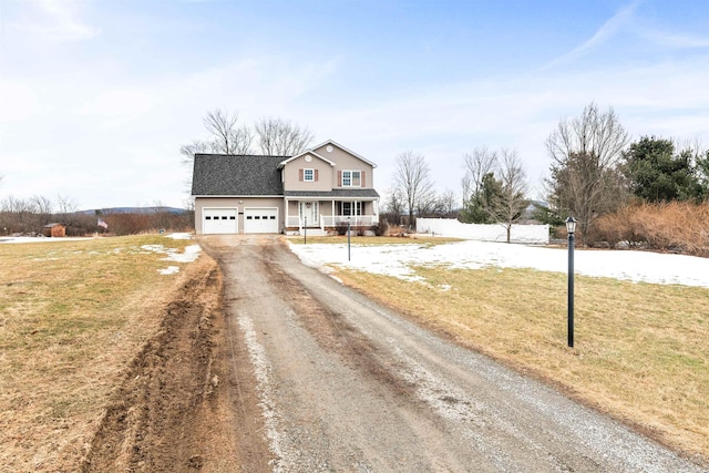 traditional home with a front yard, covered porch, a shingled roof, a garage, and dirt driveway